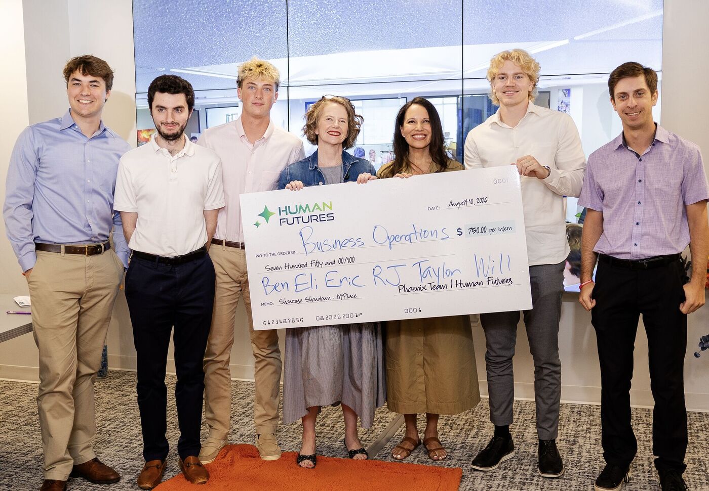 The Business Operations pod holds an oversized Human Futures check for first place