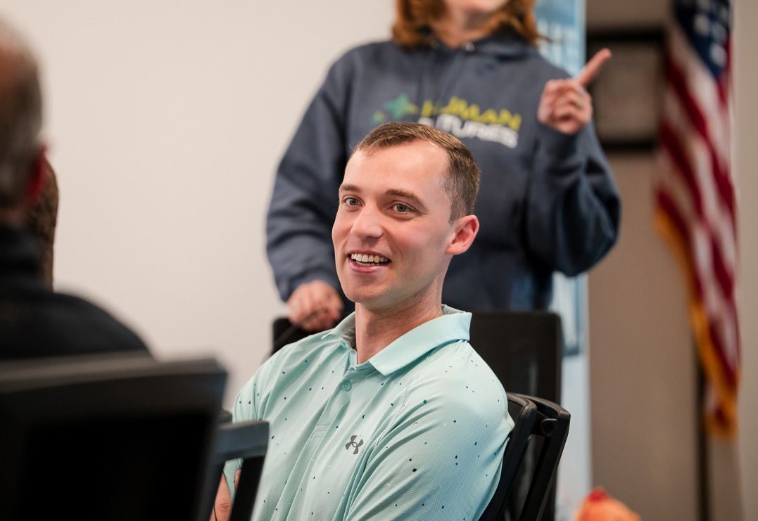 A team member laughing during a bootcamp session at the PhoenixTeam office