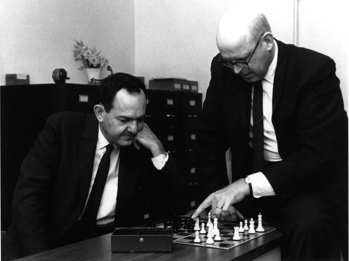 Allen Newell and Herbert Simon puzzling through the rules of chess and considering how to create a program that could think like a human. You know, just sitting around doin' math in a suit an tie.